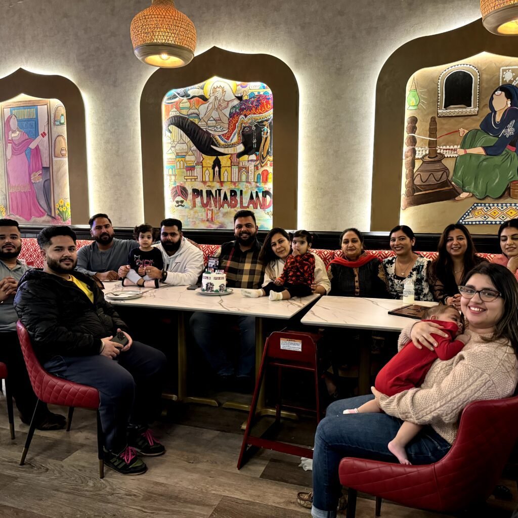family sitting at punjabland brampton